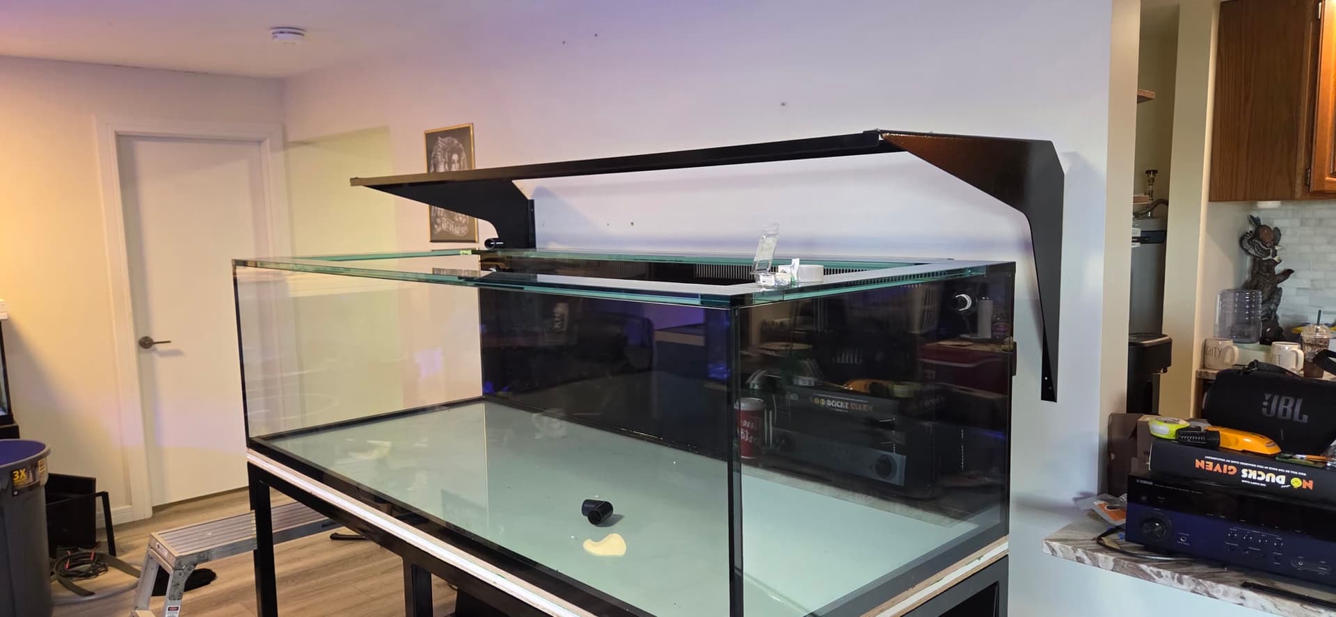 A large empty aquarium being prepared as part of a real home upgrade