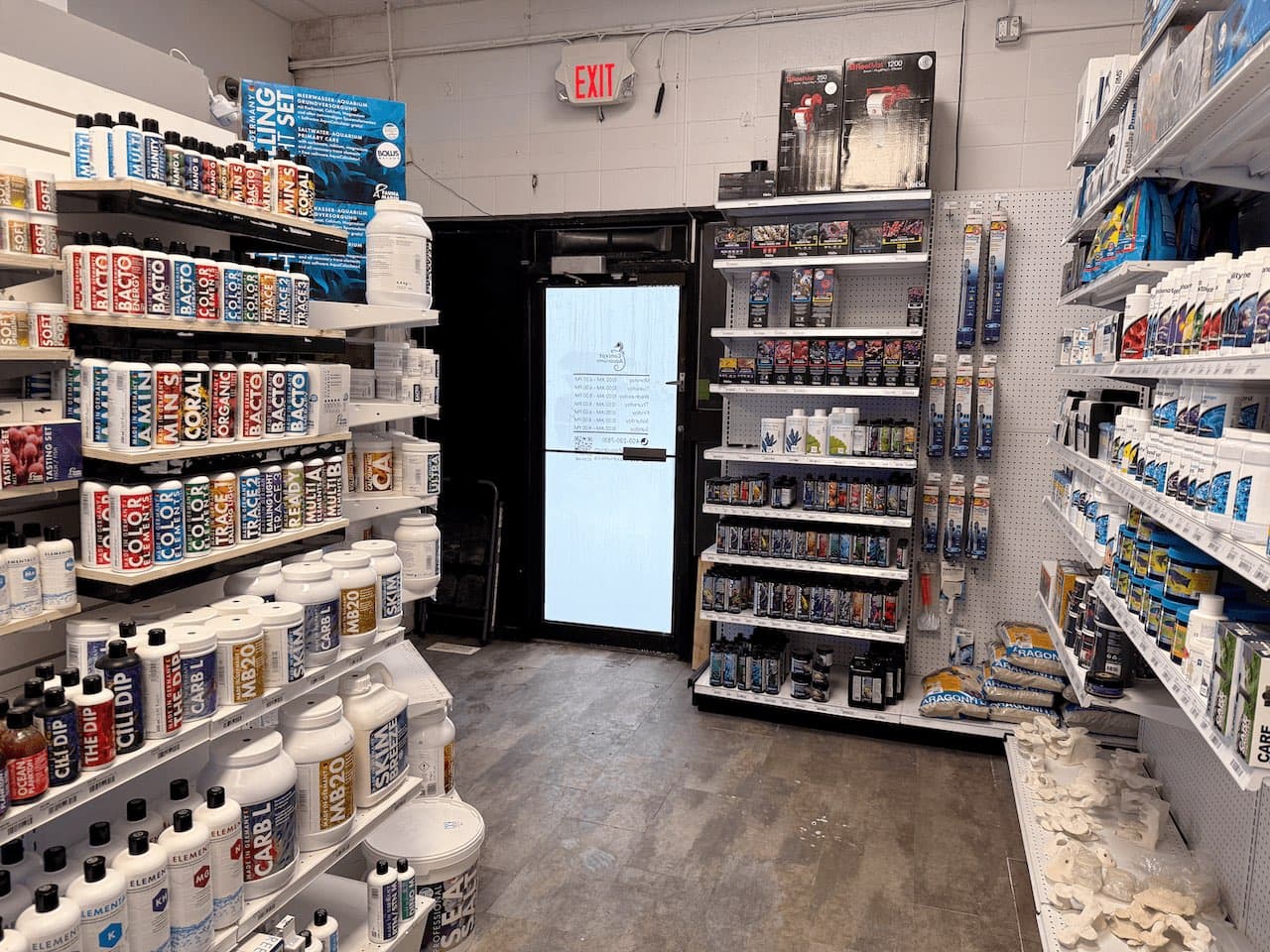 Aquarium food, testing products, and dry goods in the Concept Aquariums Calgary showroom