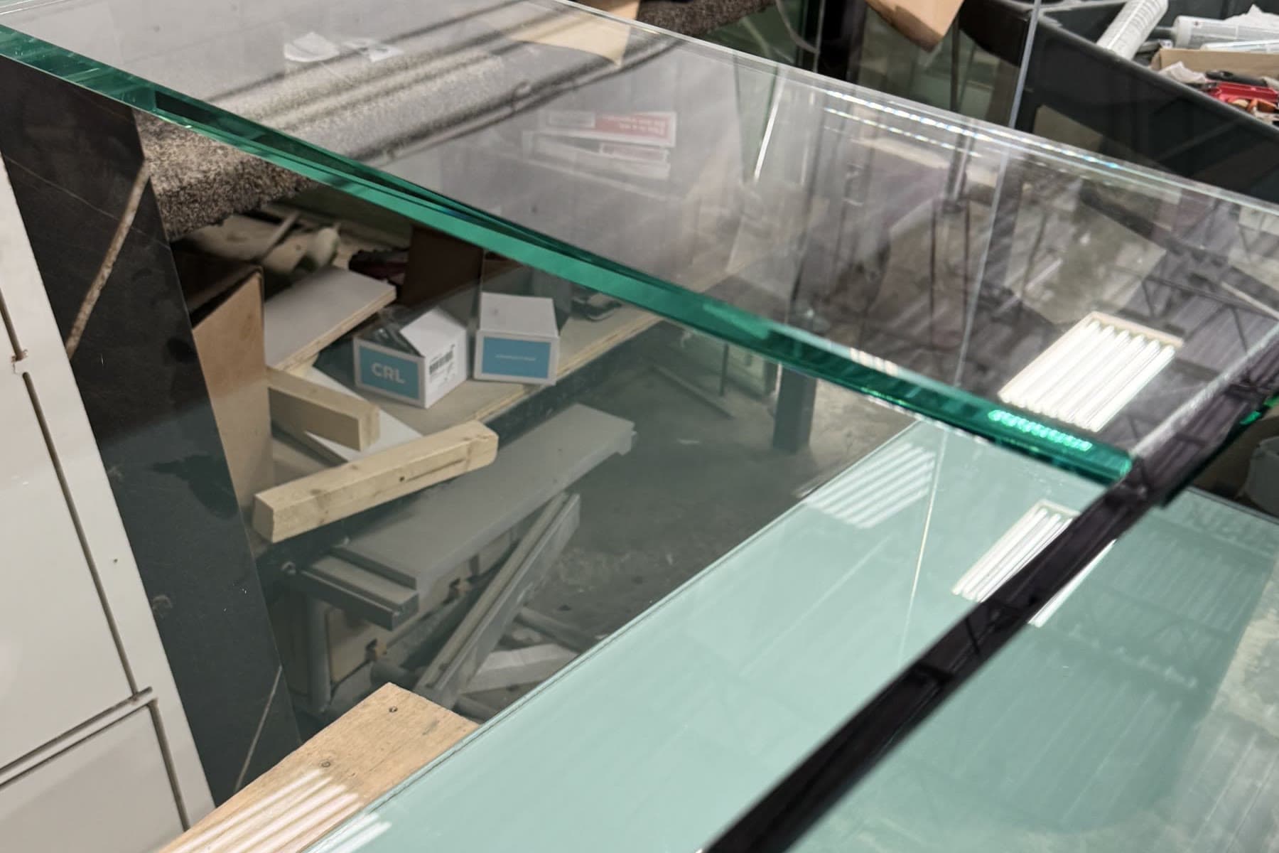 Close view of the glass edges and bracing on an aquarium in fabrication